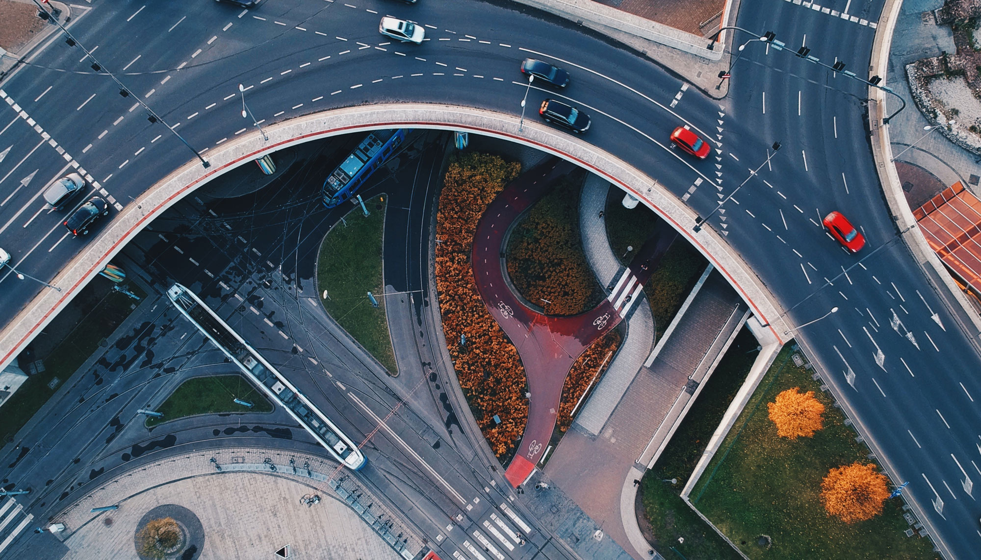 Aerial view of a city intersection with traffic, public transport, and cycle lanes